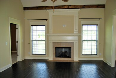 wood beams-beautiful fireplace and wood floors