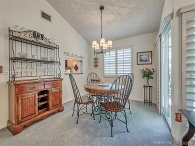 The dining area showing the kitchen pass thru and 