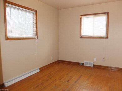 Bedroom 1 with wood flooring.