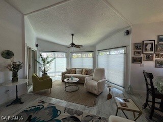 Living room with vaulted ceiling, a textured ceili