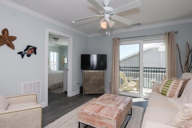 Living room featuring a ceiling fan, ornamental mo