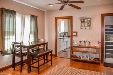 Formal dining room with wood flooring.