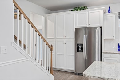 Kitchen with white cabinetry, stainless steel frid