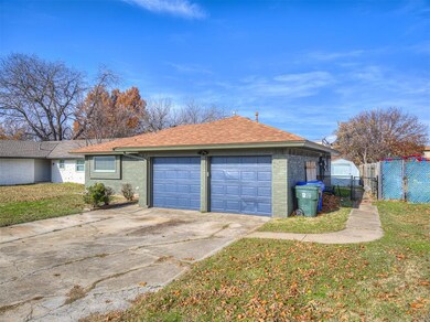 Garage featuring a lawn