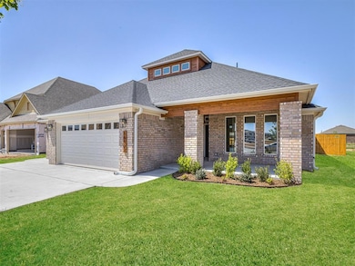 View of front facade with brick siding, a garage, roof with shingles, driveway, and covered porch