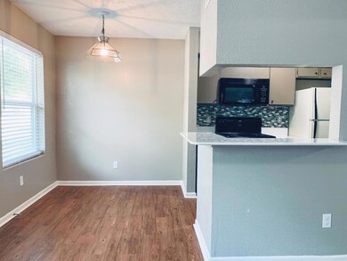 Kitchen featuring tasteful backsplash, dark wood-t