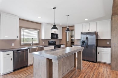 Kitchen featuring recessed lighting, a sink, blac