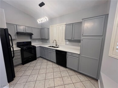 Kitchen featuring black appliances, gray cabinets,
