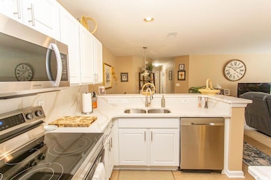 Kitchen featuring kitchen peninsula, appliances wi