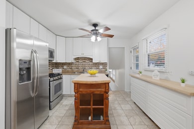 Well-appointed kitchen showcasing white cabinetry,