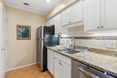 Stunning, updated kitchen featuring stainless appl, granite counters,glass tile backsplash, soft close white custom cabinets, recessed lighting, crown molding.