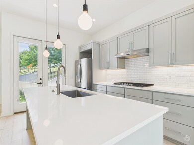Kitchen featuring gray cabinets, appliances with 