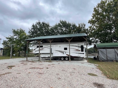 View of outbuilding with a detached carport
