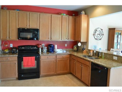 Maple cabinetry with granite countertops and elect