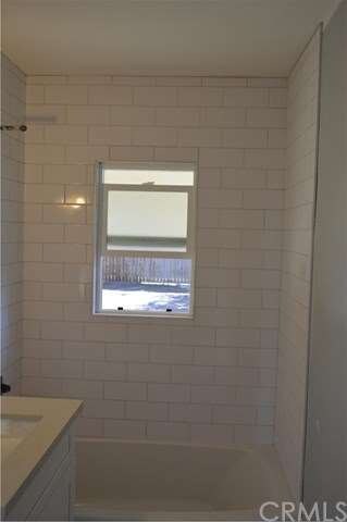 New subway tile surround in the shower with a new 