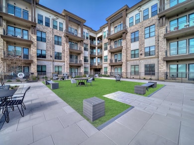 View of community featuring a lawn and fence