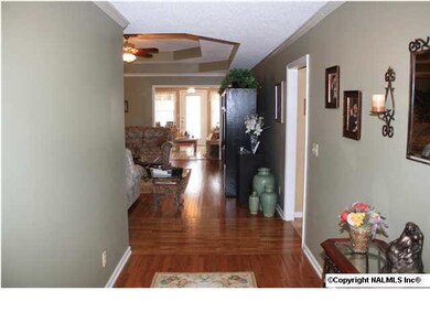 Foyer - Features gleaming hardwood flooring and crown molding.