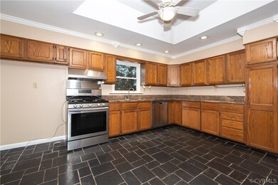 The spacious kitchen boasts a gorgeous tray ceilin
