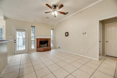 Unfurnished living room with lofted ceiling, light tile patterned floors, a textured ceiling, a fireplace, and ceiling fan