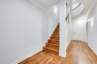 Stairway featuring crown molding and wood finished floors