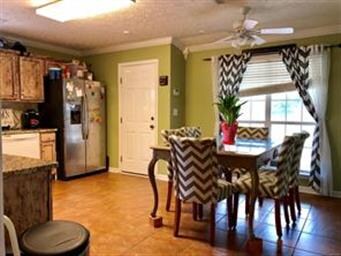 Kitchen.  Door leads to covered patio and fenced a