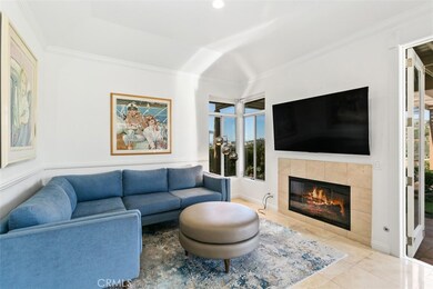 Family room with wall mounted TV and fireplace.