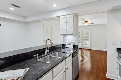 Kitchen with dark wood-style flooring, visible ven