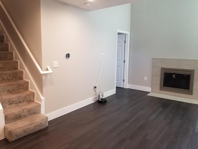 Washroom with a tile fireplace, baseboards, and d