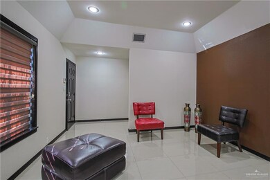 Sitting room featuring lofted ceiling and light tile patterned floors
