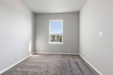 Carpeted empty room with baseboards