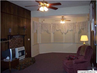 Front view of Family Room with bay window; area sized for small table or sitting area.