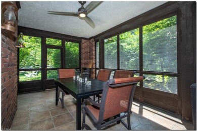 The screened porch features a tile floor, access t