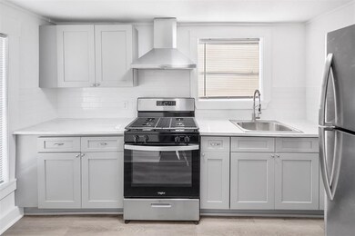 This is a modern kitchen with sleek gray cabinetry