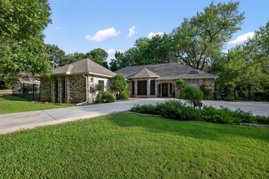 Single story home with curved driveway, brick sid