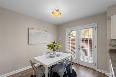 Dining space with wood finished floors and french doors