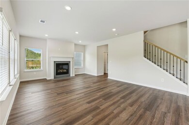 Unfurnished living room featuring dark wood-style 