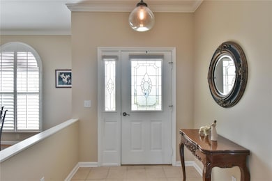 Upgraded Glass Door Entrance.  House has lovely crown molding.