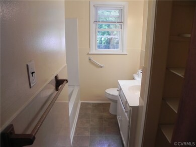 Full bathroom featuring shower / tub combination, vanity, tile patterned flooring, and toilet