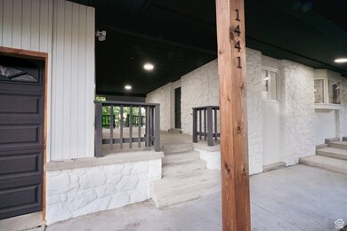 Doorway to property featuring stone siding