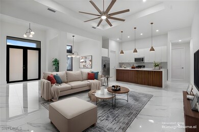 Living room with ceiling fan with notable chandeli