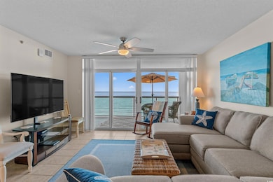 Living room with light tile patterned flooring, a textured ceiling, and a ceiling fan