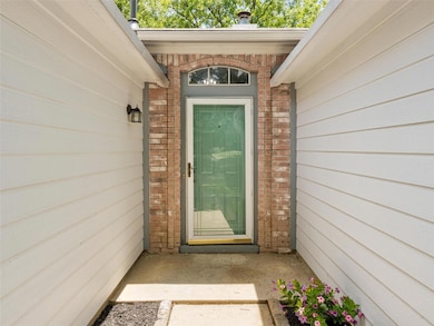 Doorway to property with brick siding