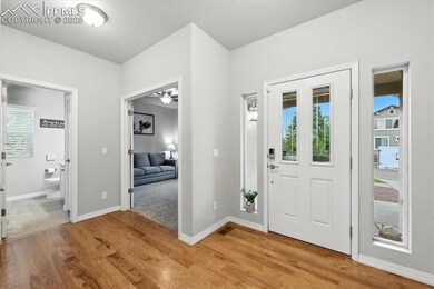Entryway with light wood-type flooring and a ceiling fan