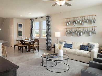 Living room with baseboards, a ceiling fan, light