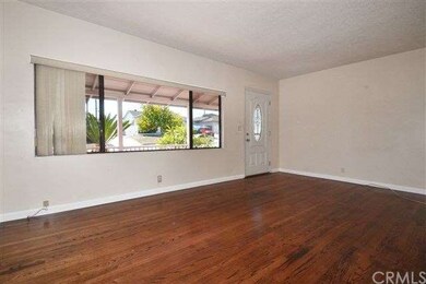 The living room has newly refinished hardwood floors along with the hallway 