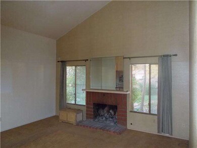 Living Room with High Ceilings and Fireplace.