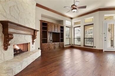 Family room features austin stone firelace and hea