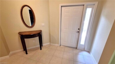 Foyer entrance with healthy amount of natural light and light tile patterned flooring
