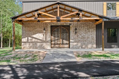 Brick entrance with double antique doors are breathtaking and a true statement piece as you welcome guests into your home.