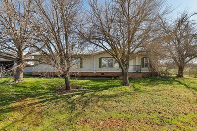 Another view of the front of the home with lots of trees.